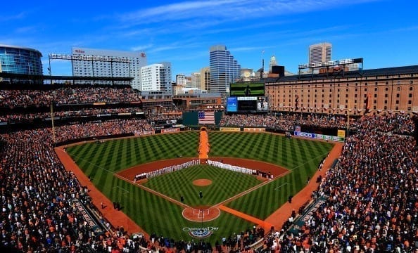 Baltimore Orioles stand on the field during the national anthem before the start of Opening Day