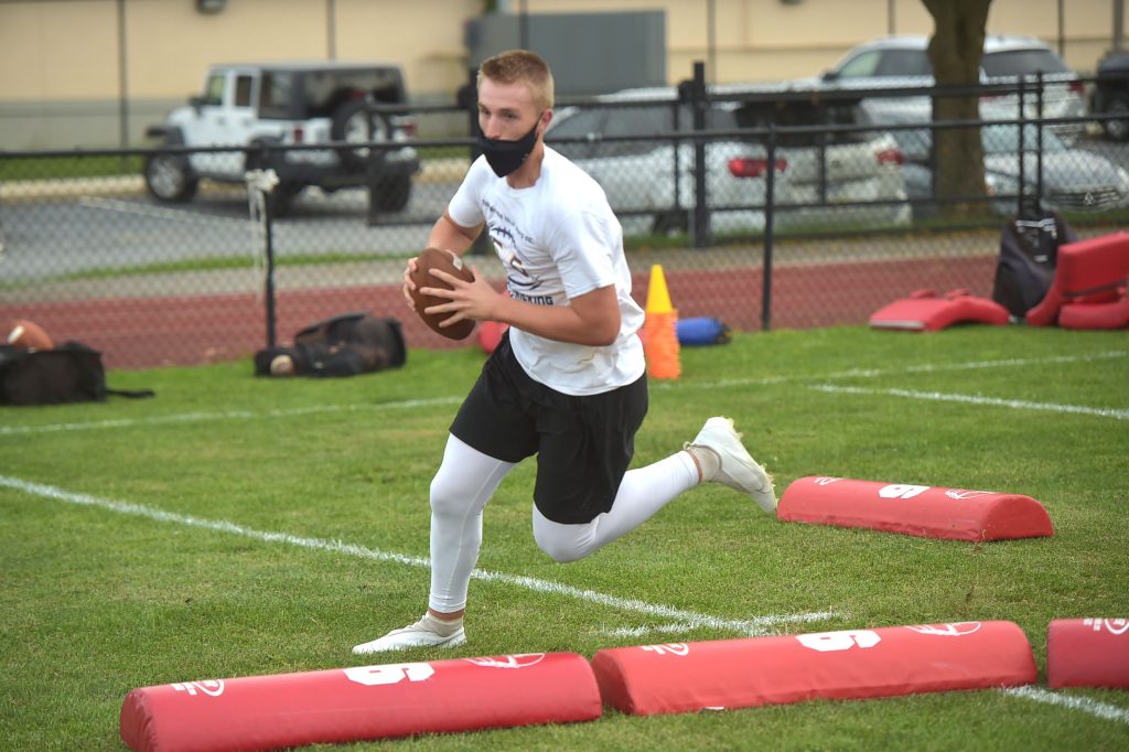West Chester East quarterback Ryan Duell rolls out during practice Wednesday.